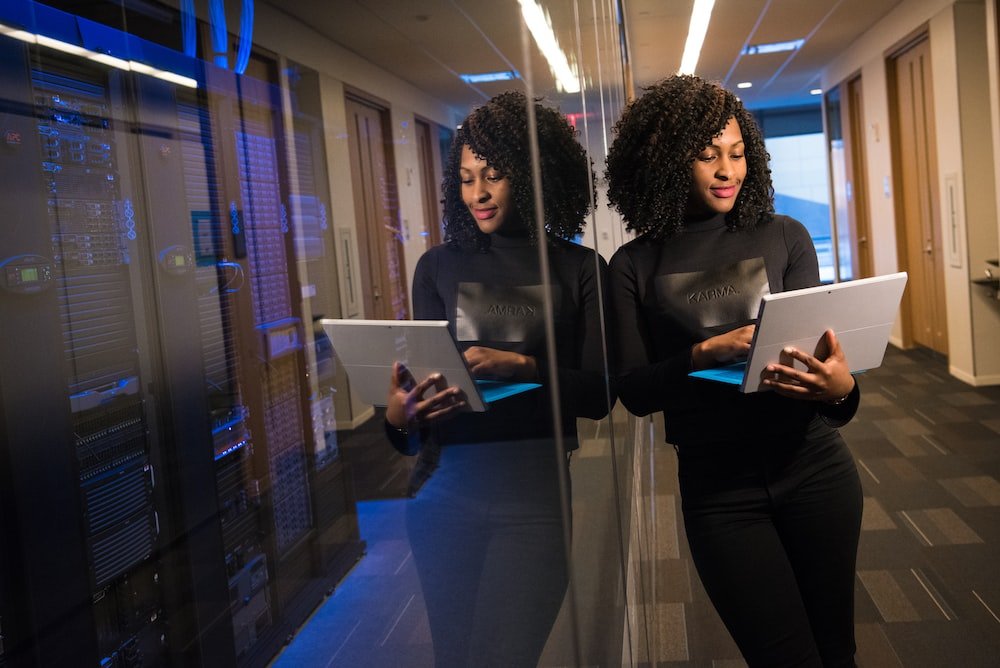 a businesswoman exploring different digital signage options on her laptop